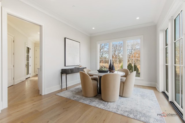 dining room featuring light hardwood / wood-style flooring and ornamental molding