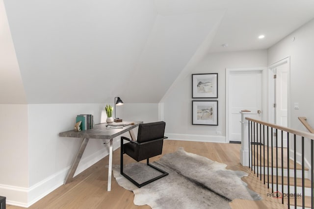 office space with lofted ceiling and light hardwood / wood-style floors