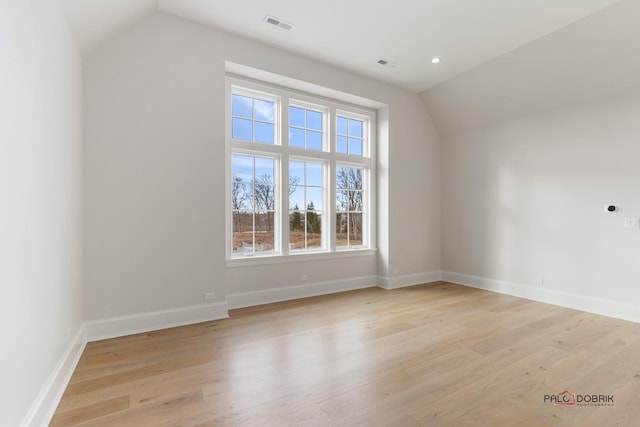 bonus room featuring lofted ceiling and light hardwood / wood-style floors