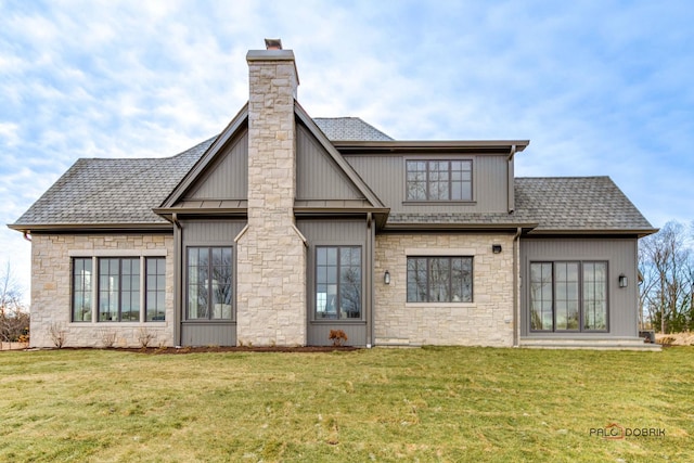 rear view of house featuring a yard