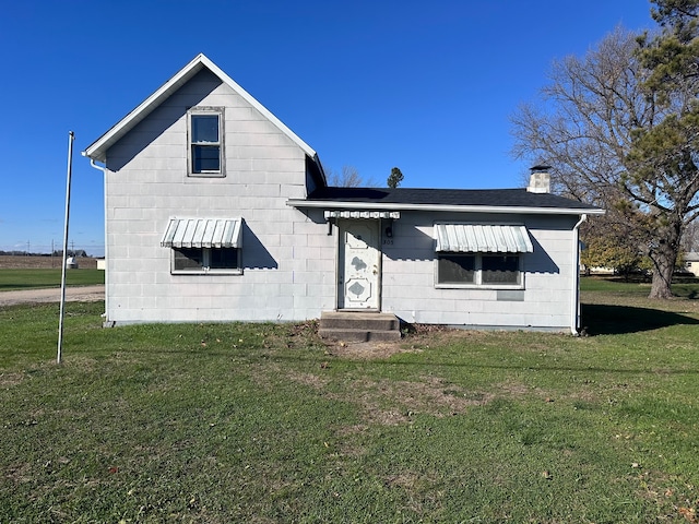 rear view of house with a yard