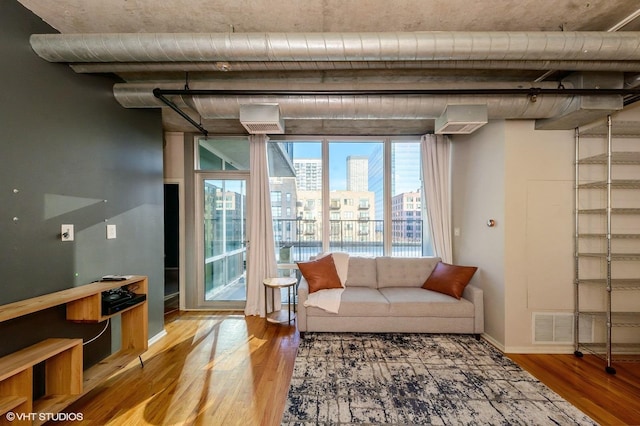 living room with a wealth of natural light and wood-type flooring