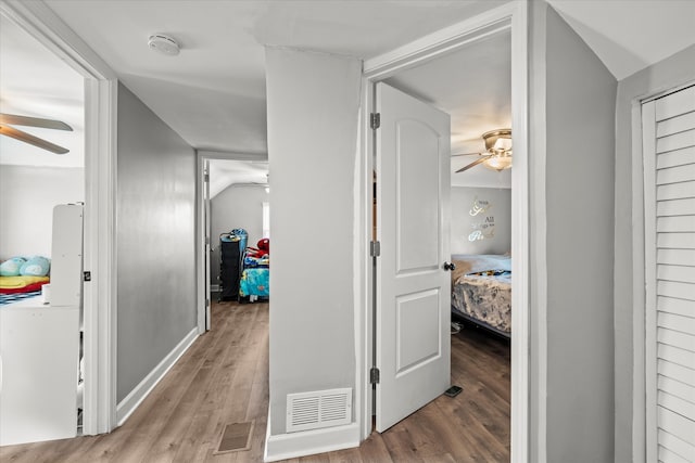 hallway with light hardwood / wood-style floors