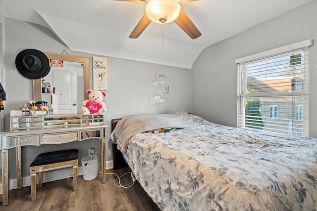 bedroom featuring ceiling fan, dark hardwood / wood-style flooring, and vaulted ceiling