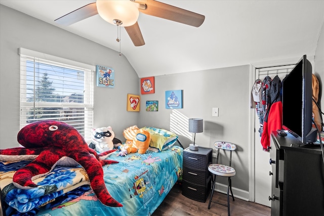 bedroom with dark hardwood / wood-style flooring, vaulted ceiling, and ceiling fan