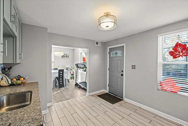 foyer featuring sink and light hardwood / wood-style flooring