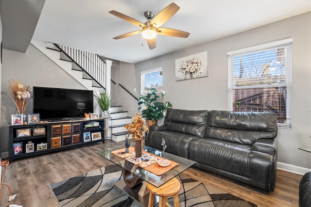 living room featuring a wealth of natural light, dark wood-type flooring, and ceiling fan