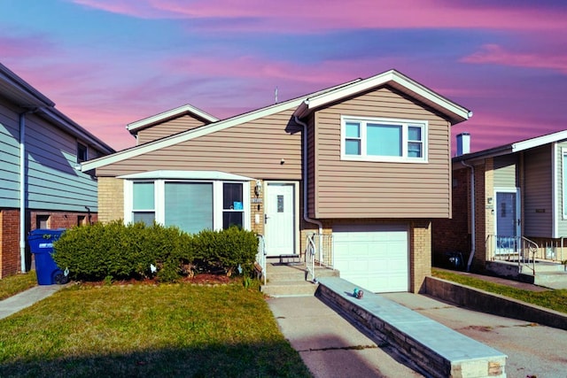 split level home with a yard and a garage