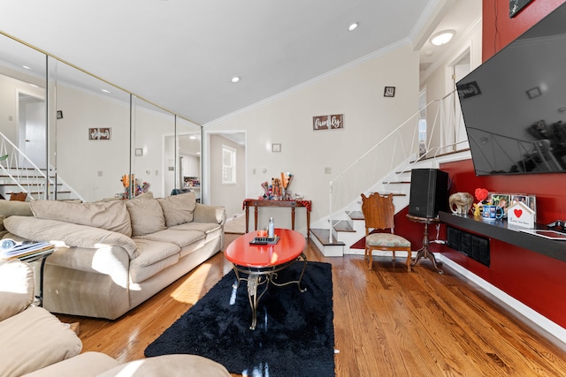 living room with hardwood / wood-style floors, crown molding, and vaulted ceiling