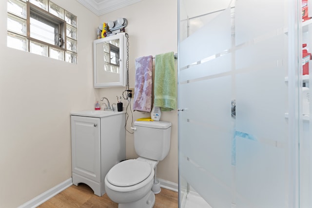 bathroom with vanity, hardwood / wood-style flooring, toilet, and crown molding