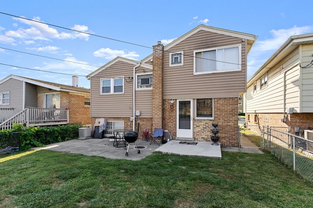 rear view of property with a yard and a patio area