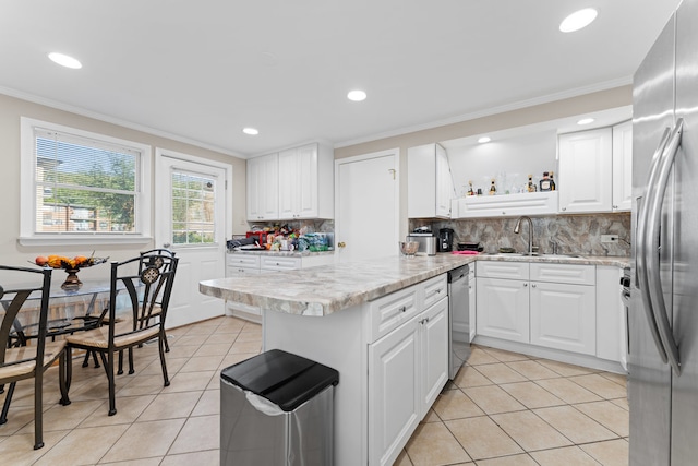 kitchen with white cabinets, light tile patterned floors, sink, and stainless steel appliances