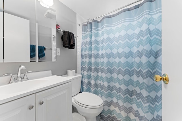 bathroom with a shower with curtain, vanity, and toilet