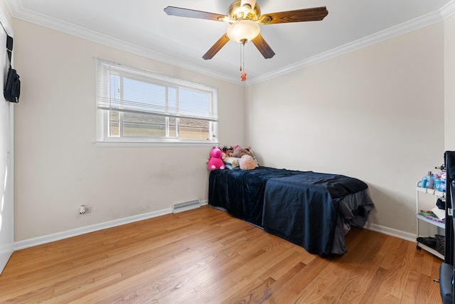 bedroom featuring ceiling fan, light wood-type flooring, and ornamental molding