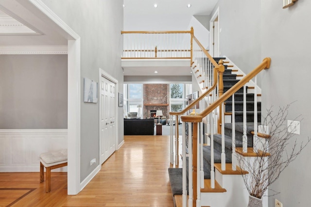 foyer entrance with a towering ceiling and light hardwood / wood-style flooring