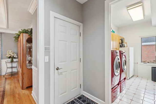 laundry room featuring independent washer and dryer and cabinets