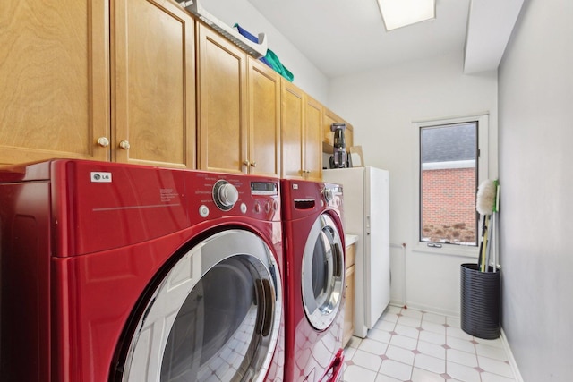 laundry area with cabinets and washing machine and clothes dryer