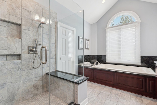 bathroom featuring tile patterned floors, independent shower and bath, and vaulted ceiling