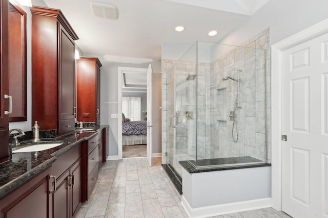 bathroom featuring vanity and a shower with shower door