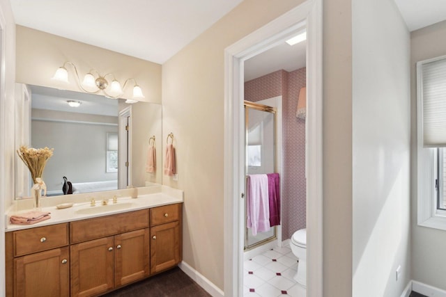 bathroom featuring vanity, toilet, and walk in shower