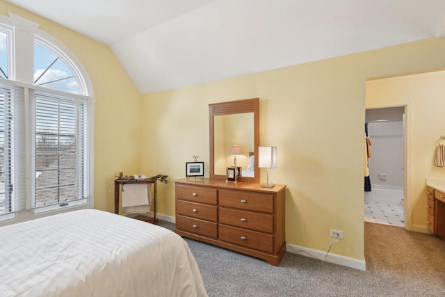 carpeted bedroom with lofted ceiling