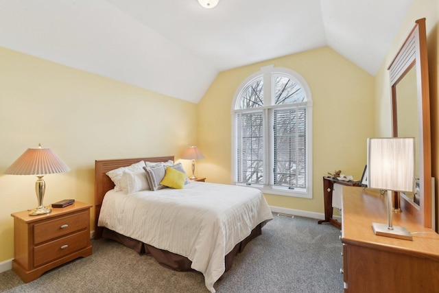 carpeted bedroom with lofted ceiling