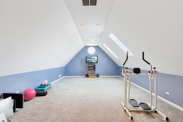 exercise room with carpet flooring and lofted ceiling with skylight