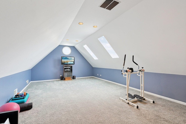 workout room featuring lofted ceiling with skylight and carpet