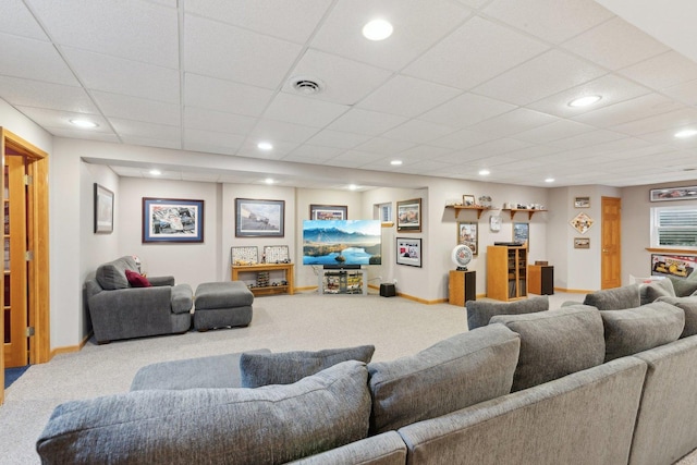 living room with carpet flooring and a drop ceiling