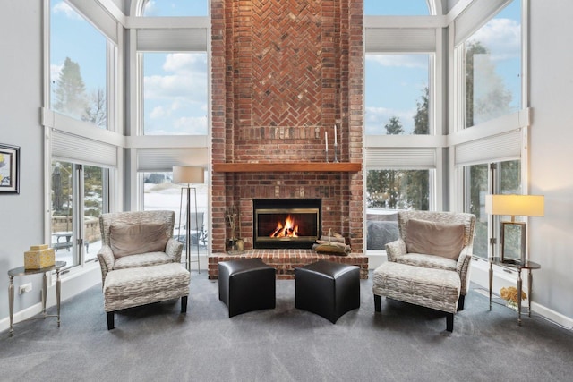 sunroom / solarium featuring a brick fireplace