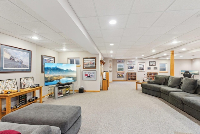 living room with a drop ceiling and carpet floors