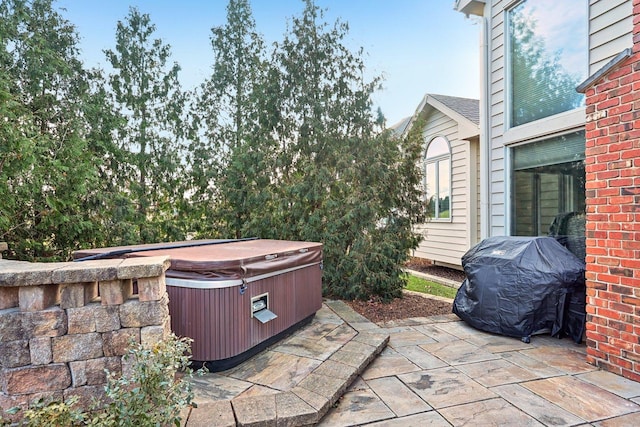 view of patio with a hot tub and grilling area