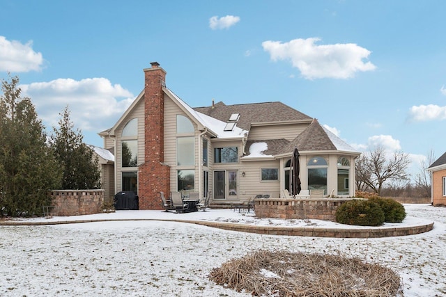 view of snow covered rear of property