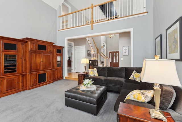 carpeted living room featuring a chandelier