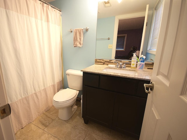 full bathroom featuring shower / bathtub combination with curtain, tile patterned flooring, vanity, and toilet