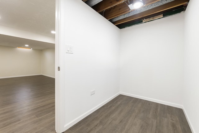 basement with dark hardwood / wood-style flooring