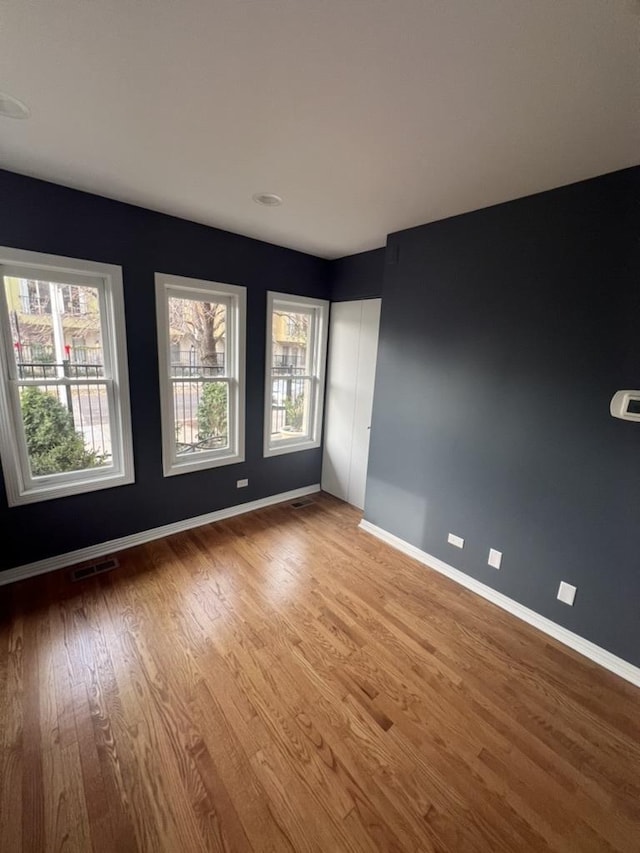 spare room with hardwood / wood-style flooring