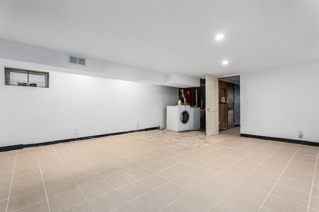 basement featuring washer / clothes dryer and light tile patterned floors