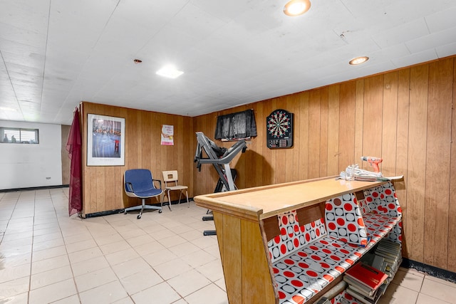 playroom featuring tile patterned floors and wooden walls