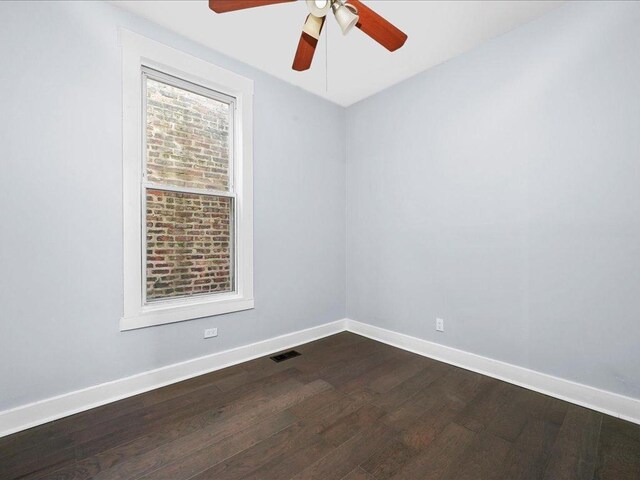 unfurnished room with ceiling fan and dark hardwood / wood-style flooring