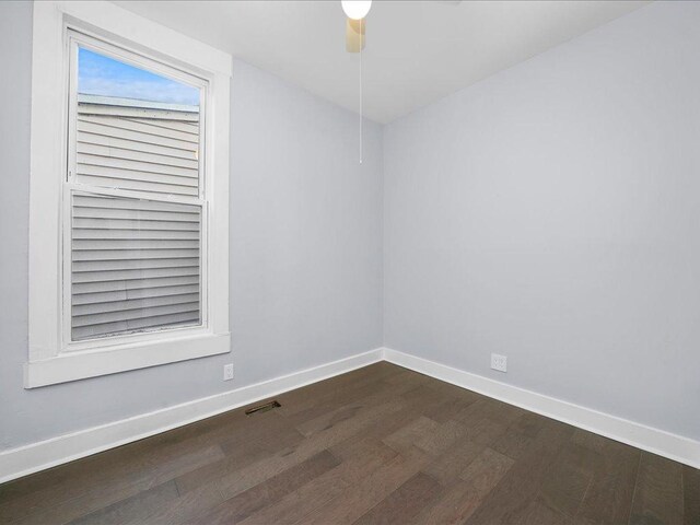 empty room featuring ceiling fan and dark wood-type flooring