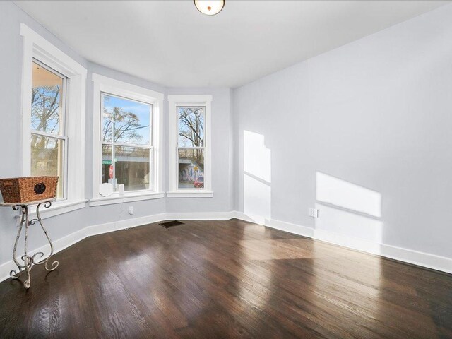 empty room with hardwood / wood-style floors