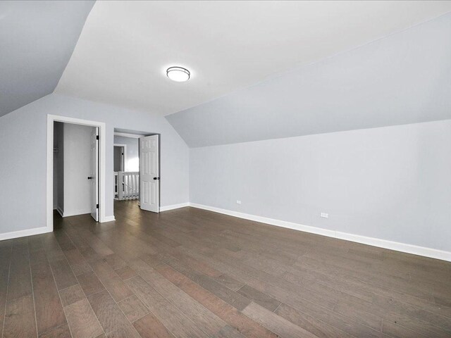 bonus room featuring dark hardwood / wood-style flooring and lofted ceiling