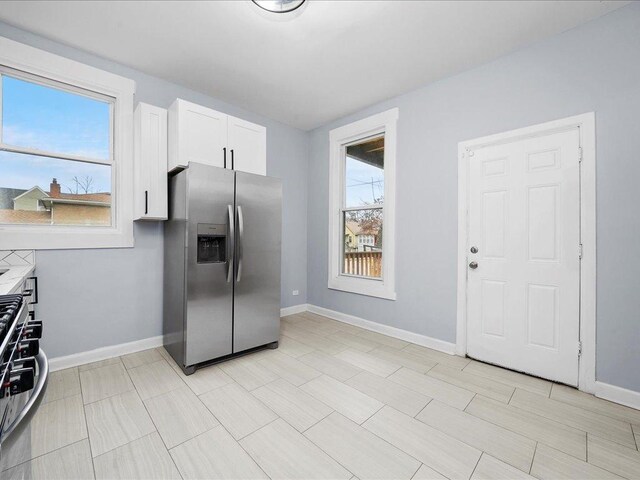 kitchen featuring white cabinetry, plenty of natural light, and stainless steel appliances