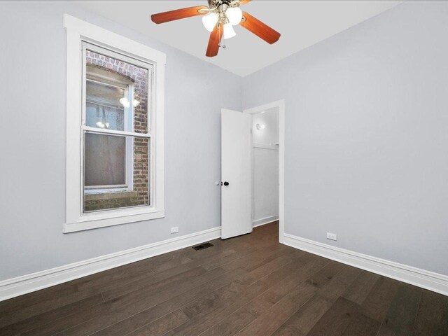 spare room featuring ceiling fan and dark wood-type flooring