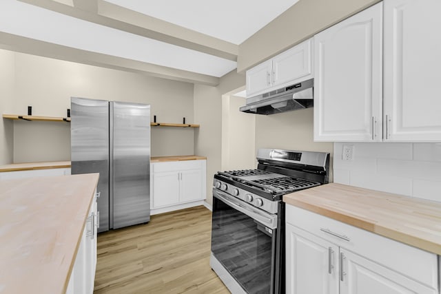 kitchen with butcher block counters, white cabinetry, stainless steel appliances, tasteful backsplash, and light hardwood / wood-style flooring