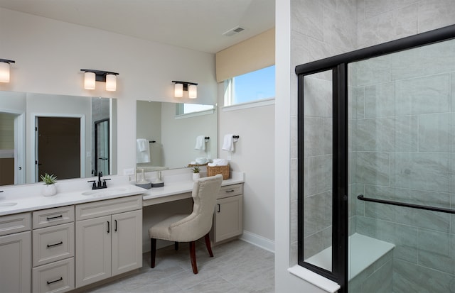 bathroom featuring vanity, tile patterned floors, and an enclosed shower