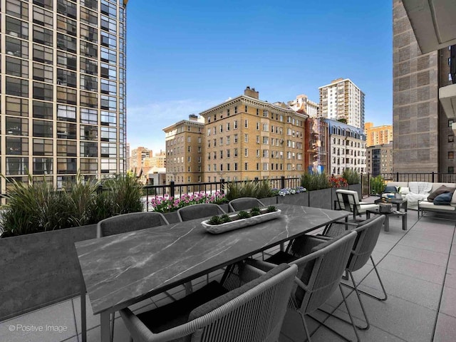 view of patio featuring an outdoor hangout area, a city view, and outdoor dining space