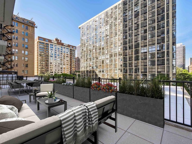 view of patio with an outdoor living space and a city view