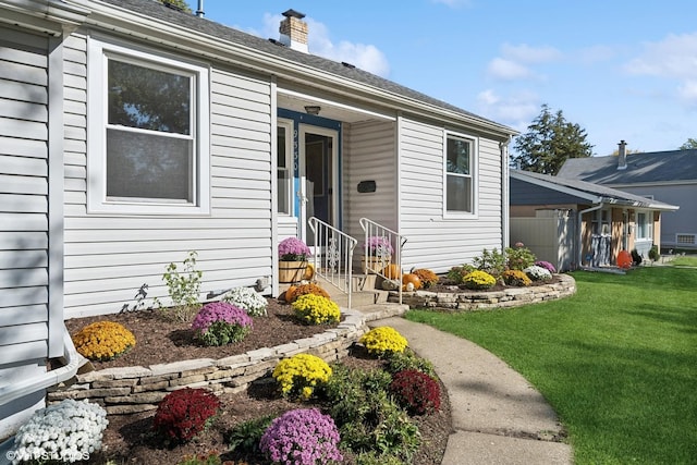 doorway to property featuring a lawn